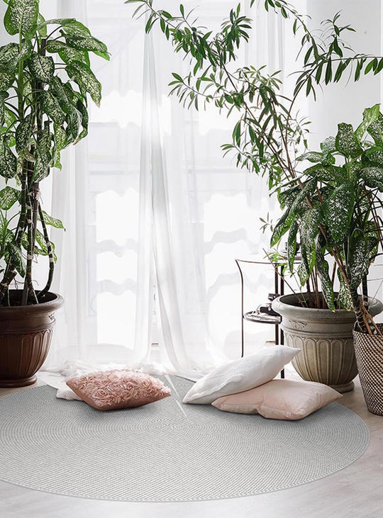 Tapis rond Caracol d'Adama Alma, vinyle durable et antidérapant pour intérieur élégant. beige