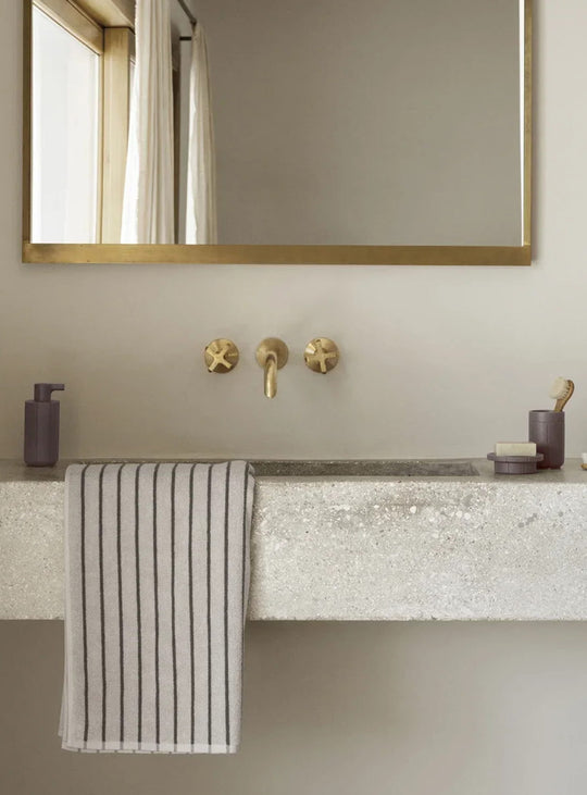 Distributeur de savon Blomus Kua, compact et rechargeable, avec une élégante finition d'aspect minéral.