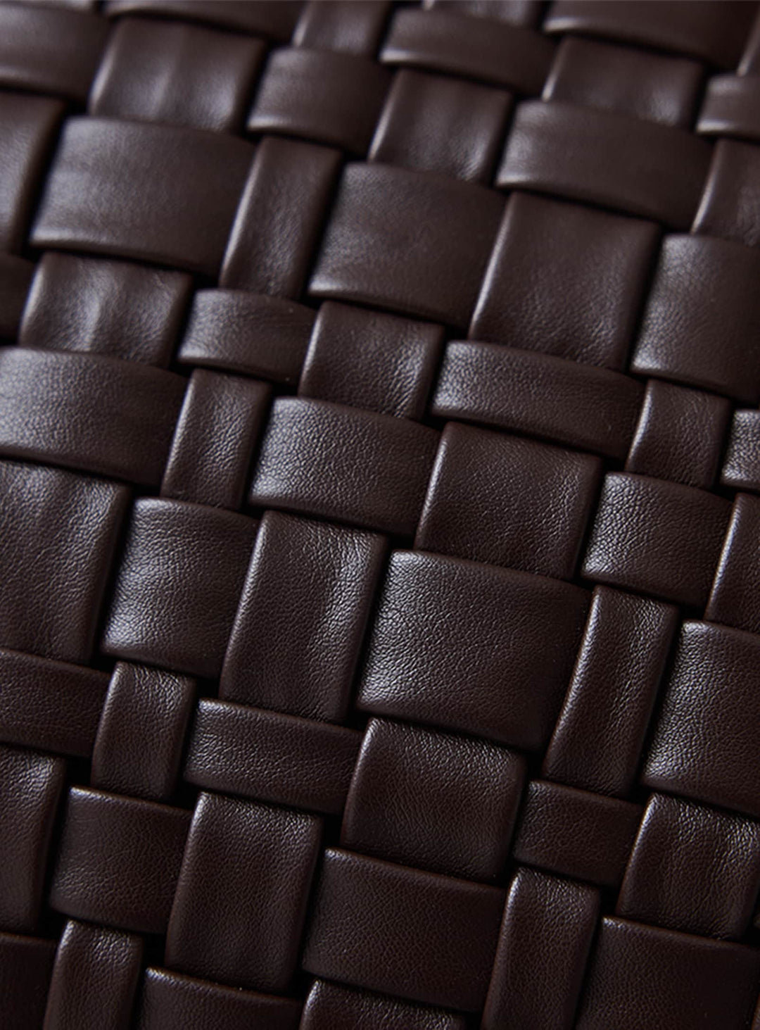 Le coussin tressé brun chocolat de HKliving associe texture quadrillée, confort moelleux et style contemporain.