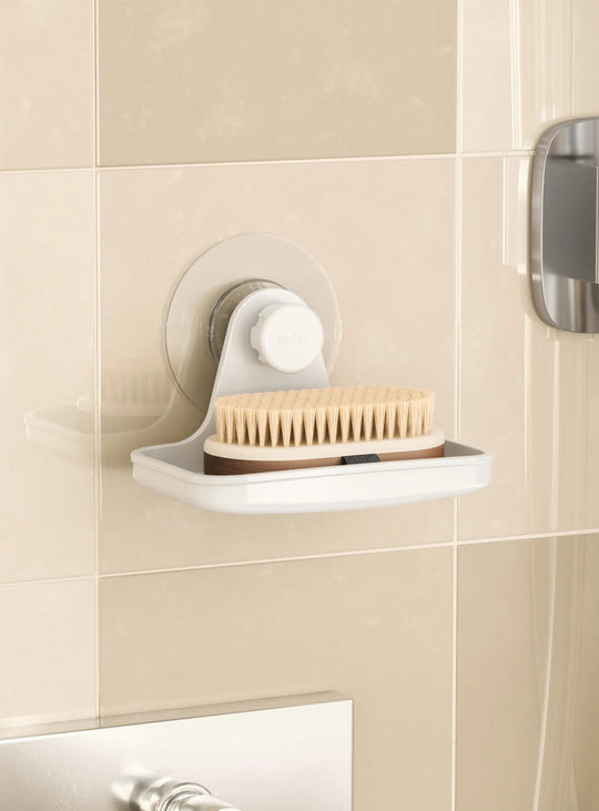 Porte-savon Flex Adhesive d'Umbra avec drainage intégré et fixation adhésive sans perçage pour la douche.