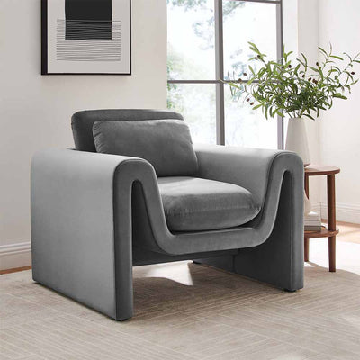 Le fauteuil Waverly, une œuvre d'art luxueuse. Lignes ondulées, bords arrondis, mousse dense : confort et élégance se rencontrent. Choisissez entre tissu bouclé et velours pour une expérience sensorielle unique.