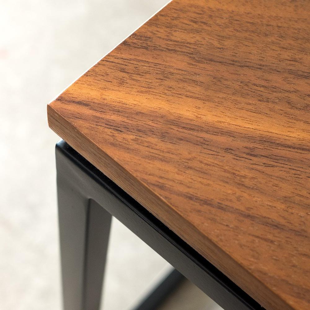 La table d'appoint Tobias de Gus* Modern est une pièce géométrique minimaliste bien adaptée aux espaces de vie modernes. Minimale, elle demeure forte de son contraste bois et métal associé à une structure toute en finesse.